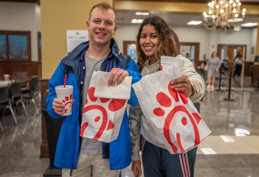 Students holding Chik-fil-A bags