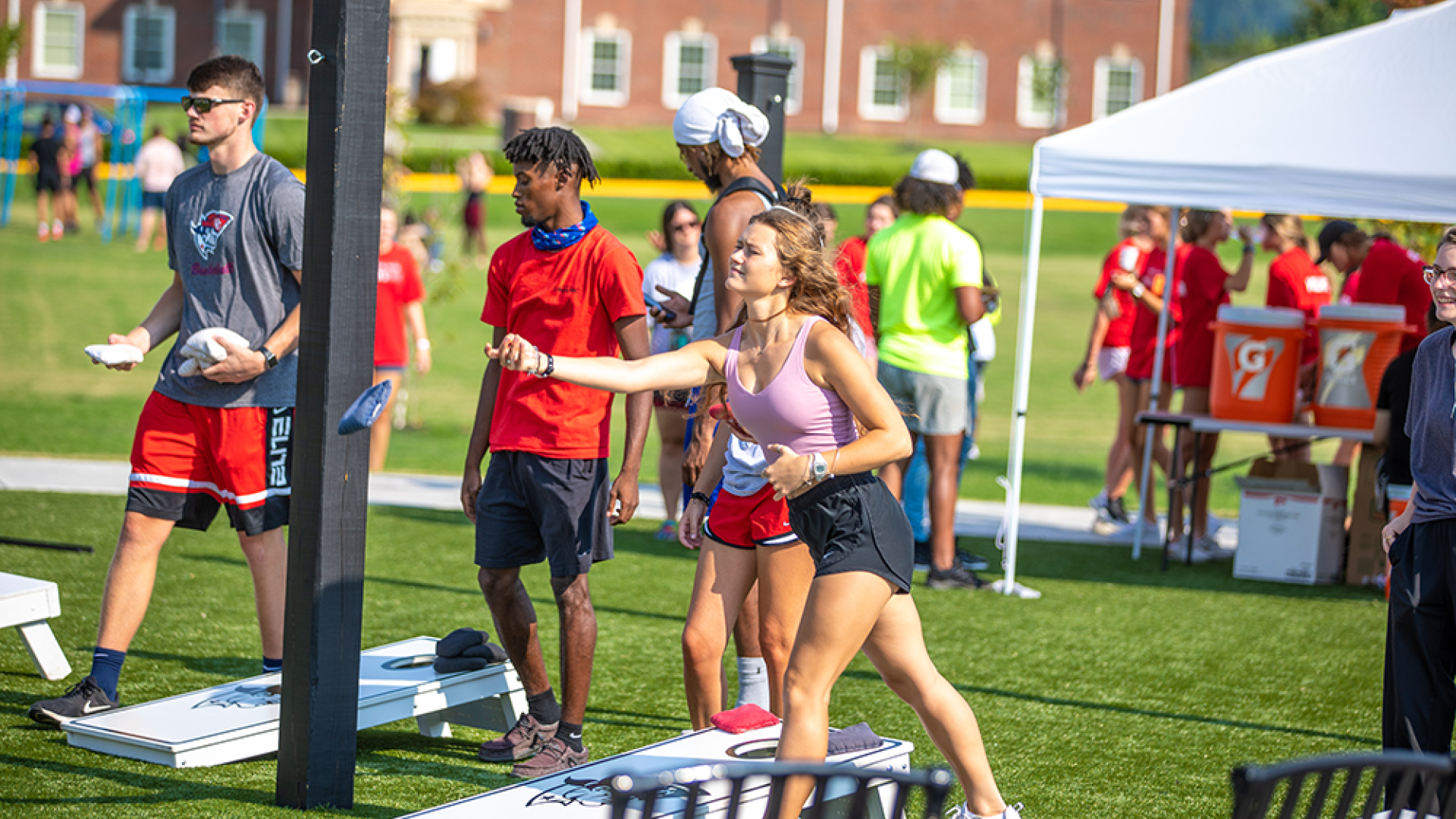Students playing cornhole at campus event