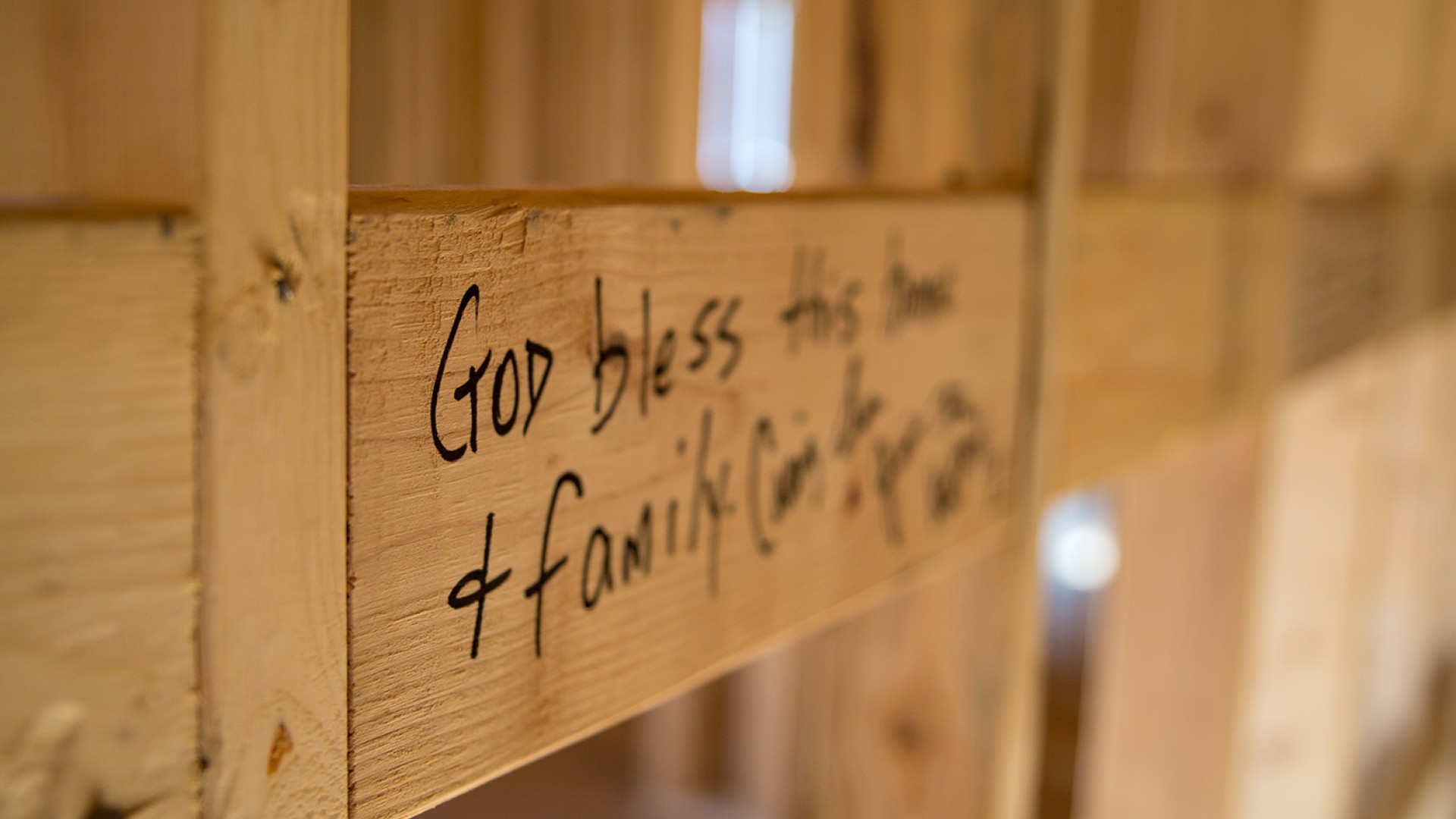 A Biblical saying is written on the wall of a Mountain Outreach home