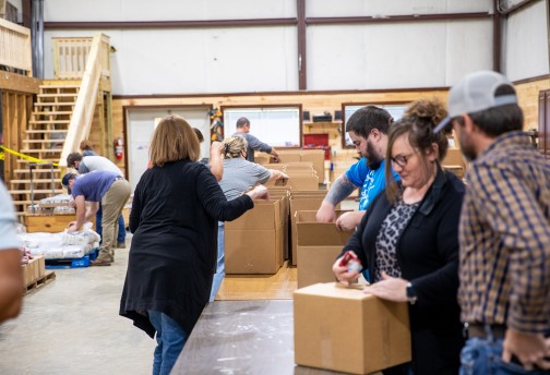 Volunteers help fill food boxes for local families