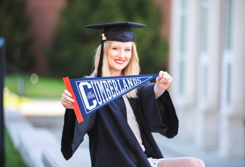 A graduate shows off her Cumberlands pennant 