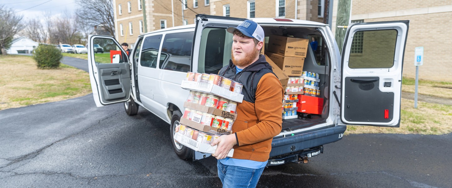 Students help deliver food to a local church food pantry during the annual food drive 