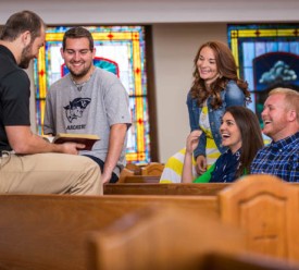 students discuss scripture inside church