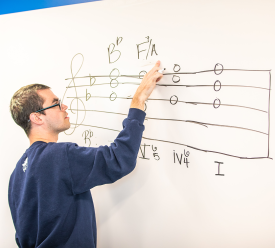 A music student practices music dictation