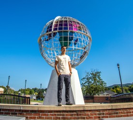 A Cumberlands student stands near the globe on campus